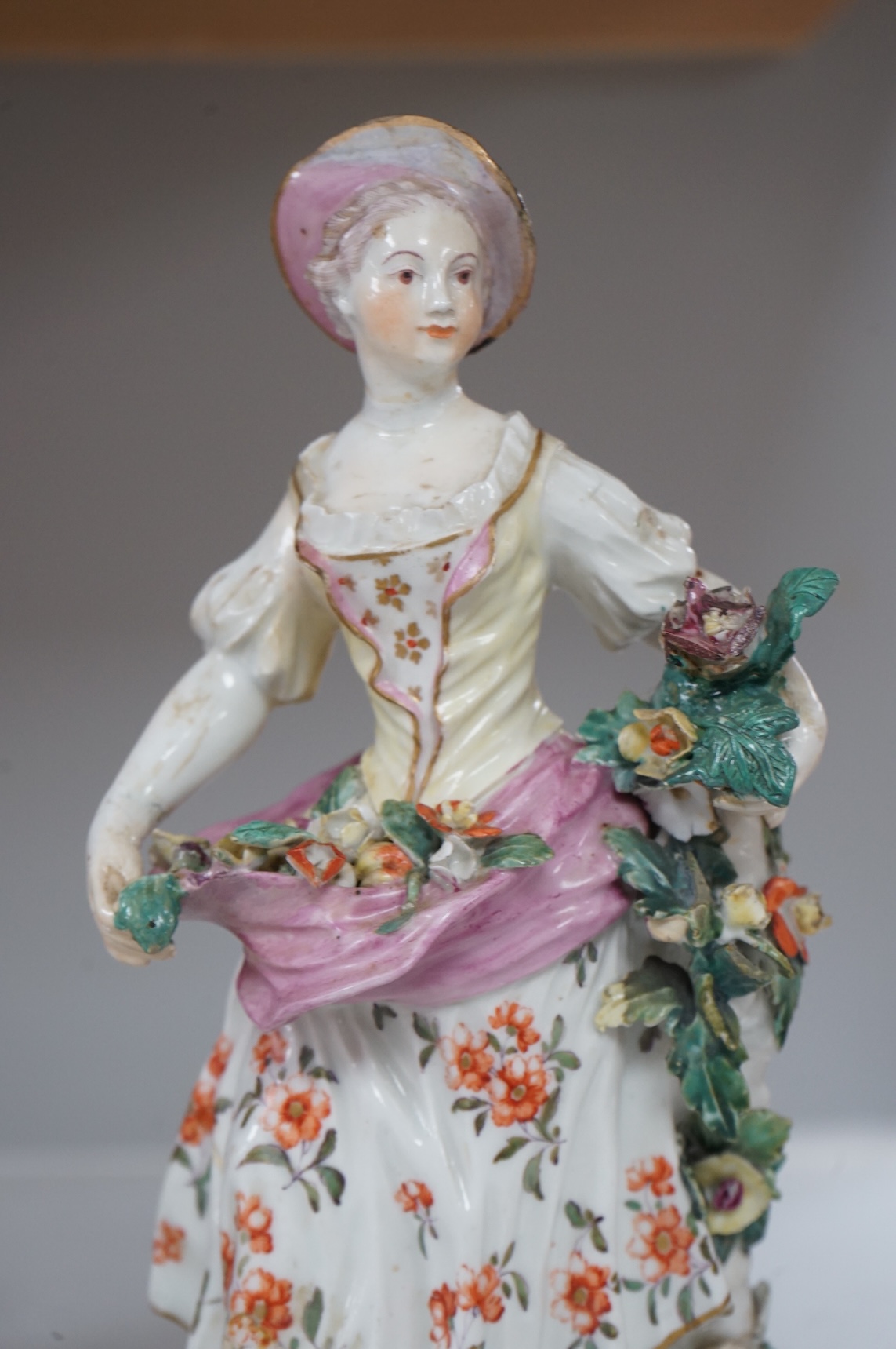 A Derby figure of a flower seller, c.1760, restored, 24cm high